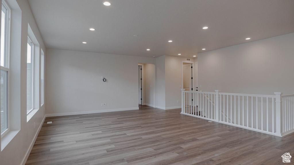 Unfurnished room with light wood finished floors and recessed lighting