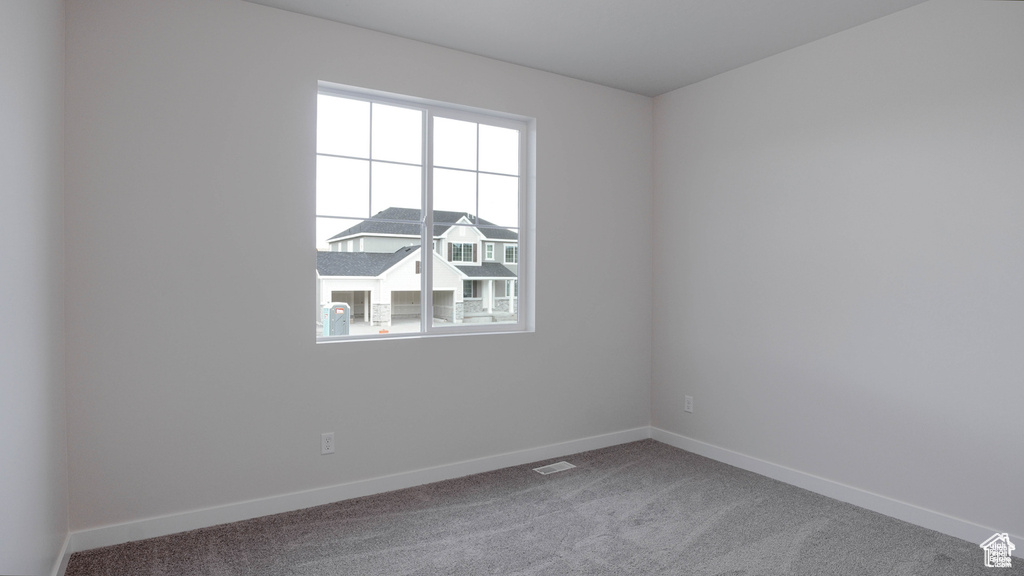 Unfurnished room with carpet flooring and baseboards