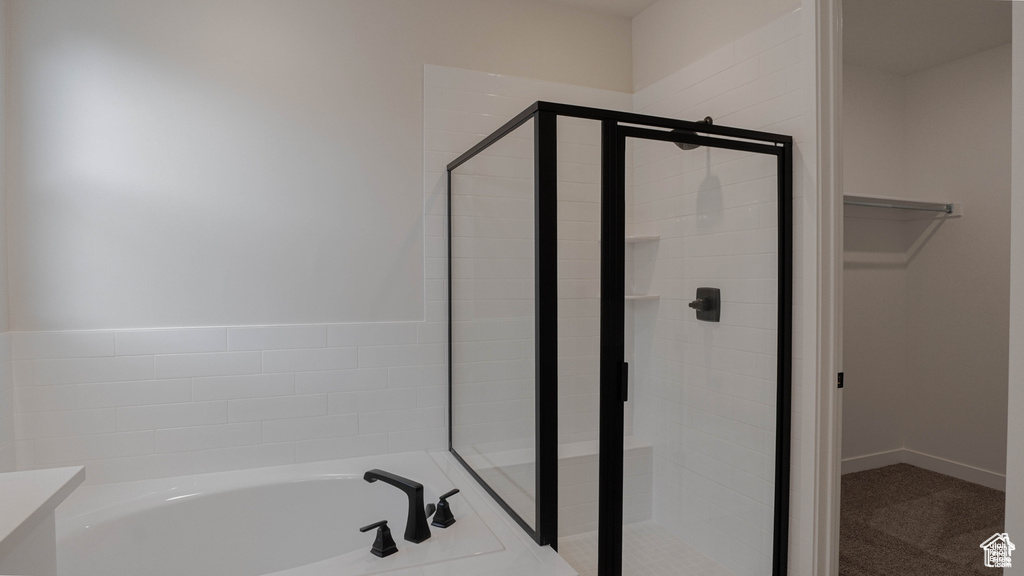 Full bath featuring a stall shower, a bath, and vanity