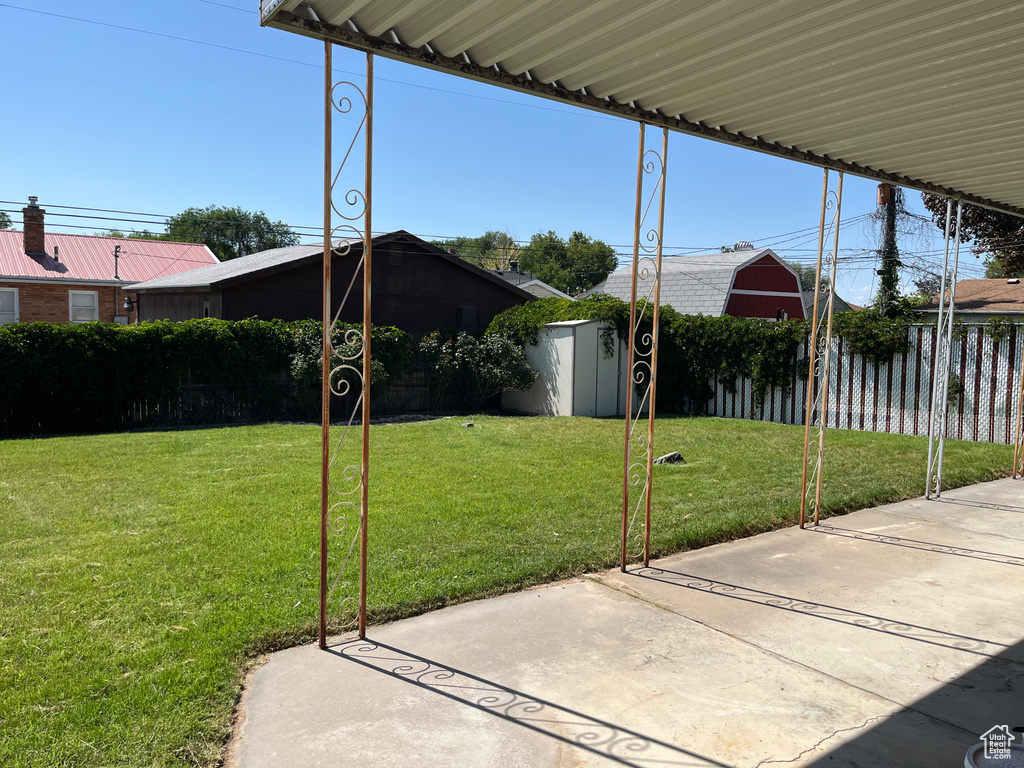 View of yard with a storage unit