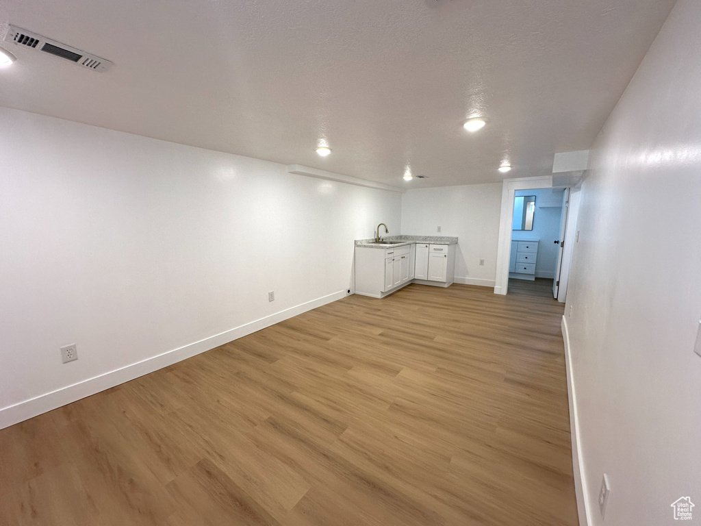 Finished below grade area featuring light wood-style floors