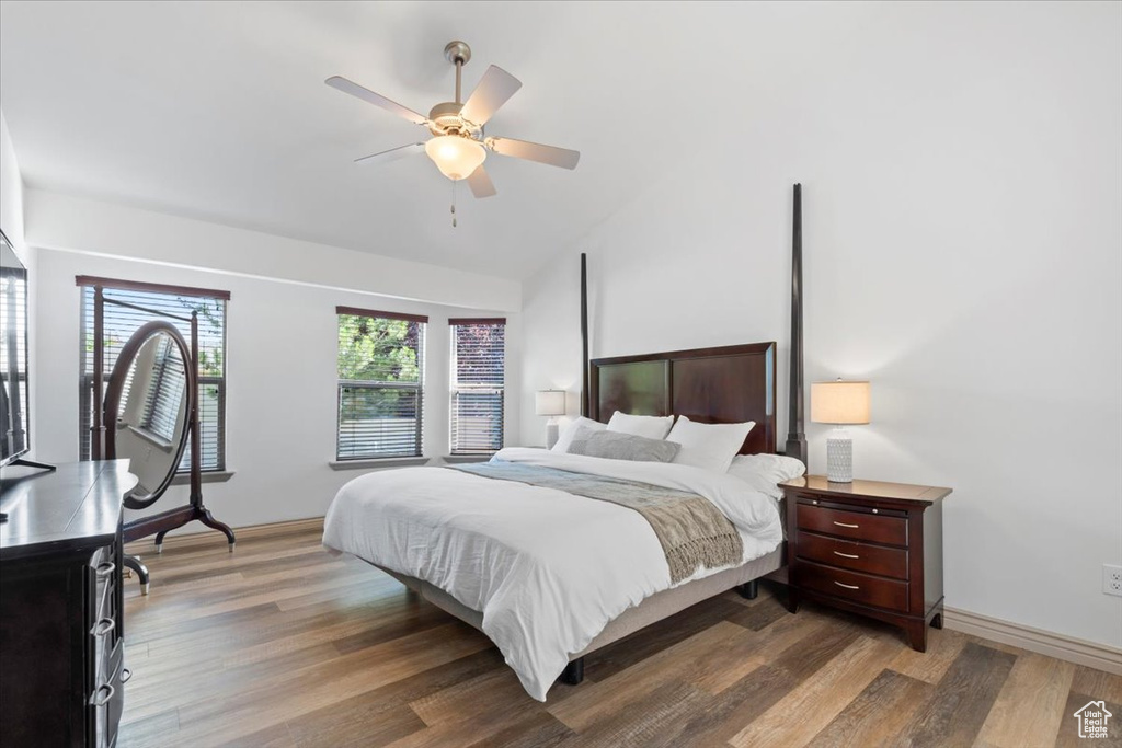 Bedroom featuring wood finished floors, lofted ceiling, and ceiling fan