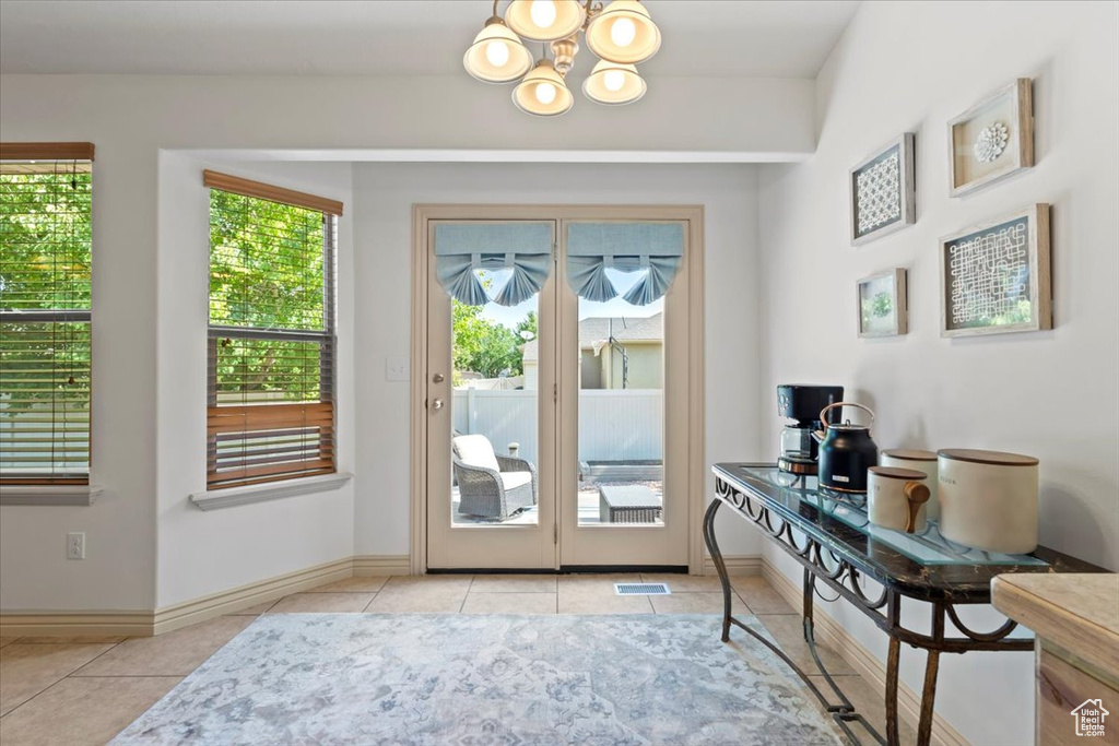 Entryway featuring tile patterned flooring, a chandelier, and an office area