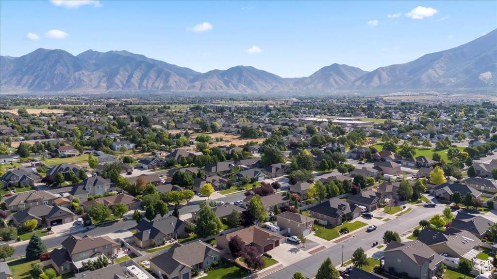 Aerial view of property's location featuring mountains and nearby suburban area