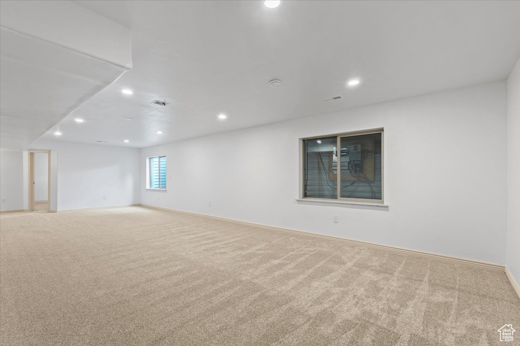 Carpeted empty room featuring recessed lighting
