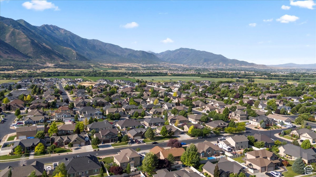 Aerial overview of property's location featuring mountains and nearby suburban area