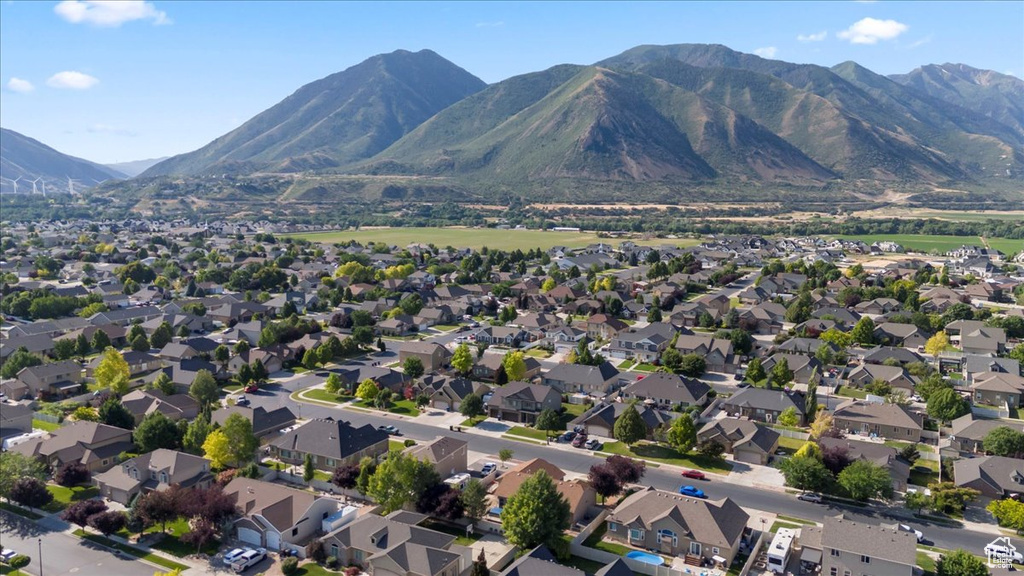Aerial overview of property's location with a mountain backdrop and nearby suburban area