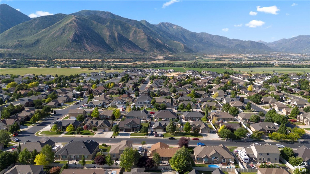 View of property location featuring nearby suburban area and a mountain backdrop