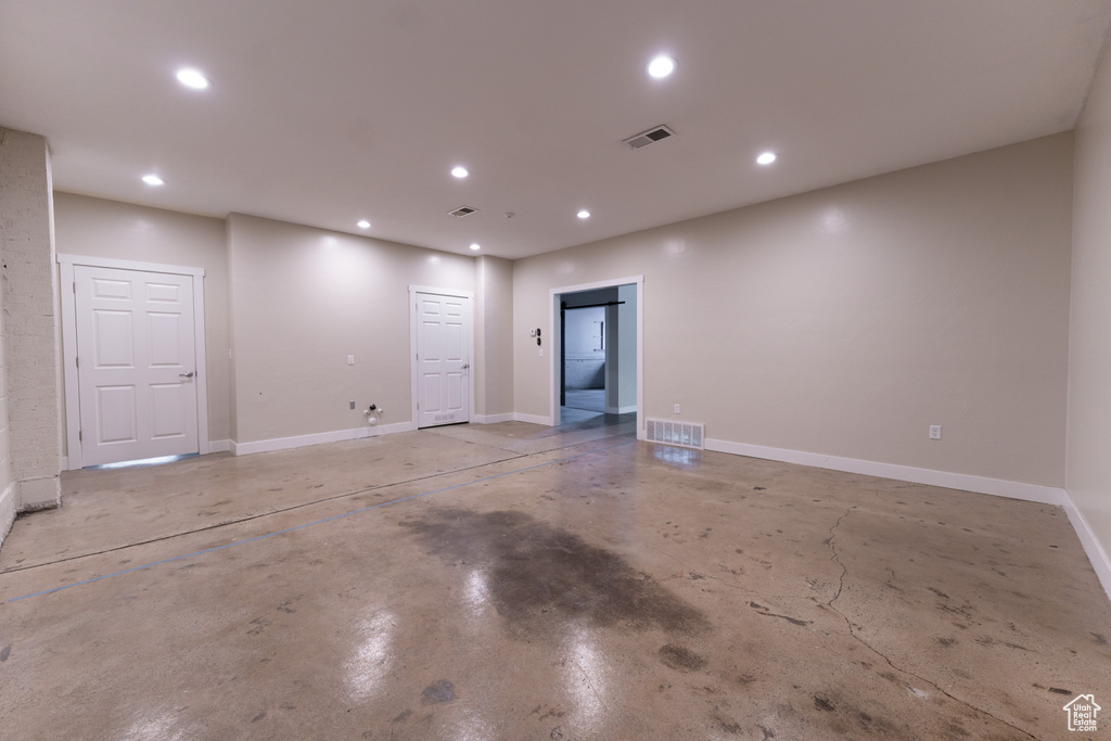 Unfurnished room with recessed lighting and concrete flooring