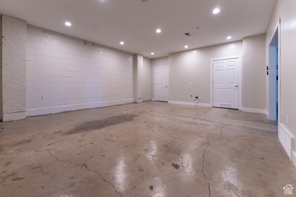 Below grade area featuring recessed lighting and concrete block wall