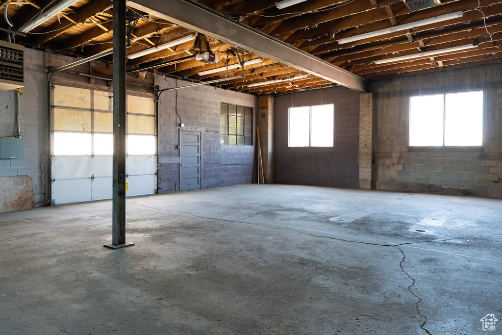 Garage with a garage door opener and concrete block wall