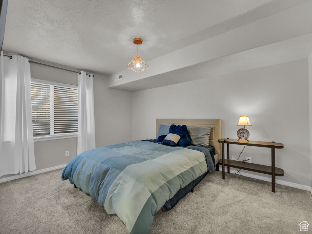 Bedroom featuring carpet flooring and baseboards