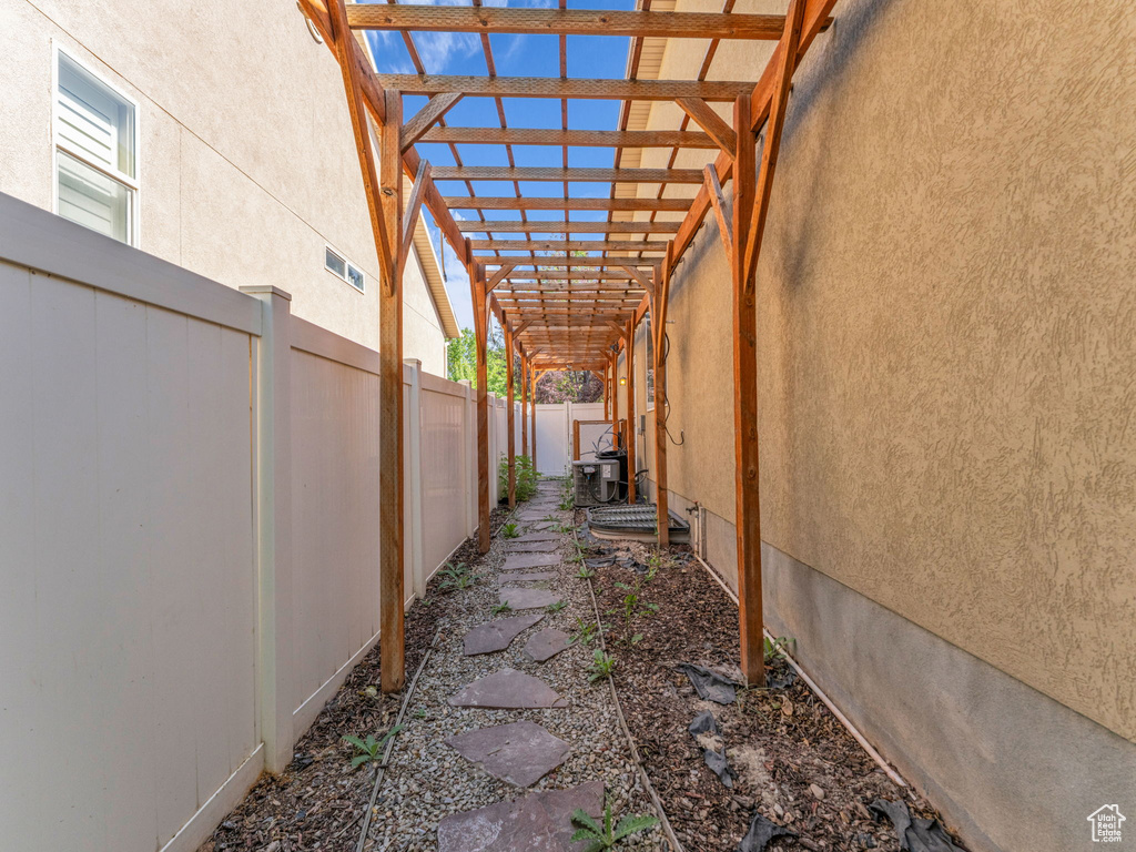 Fenced backyard featuring a pergola