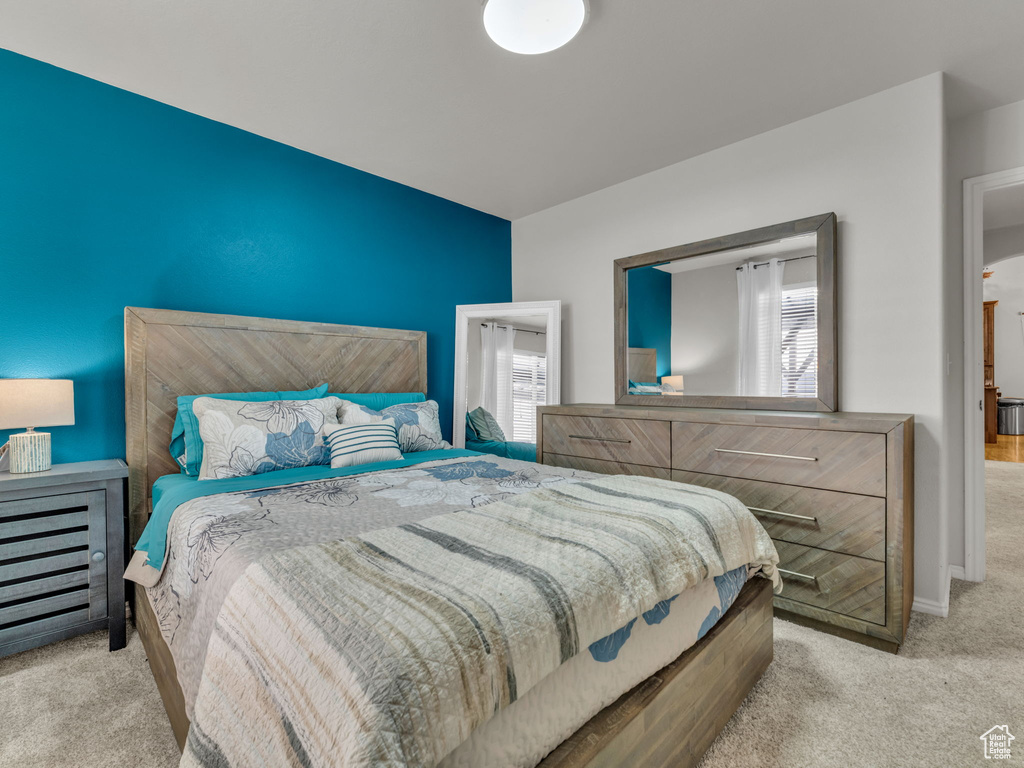 Bedroom featuring carpet floors and multiple windows