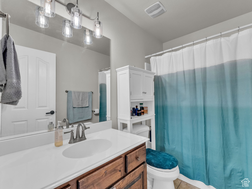 Bathroom featuring vanity, tile patterned flooring, and a shower with curtain