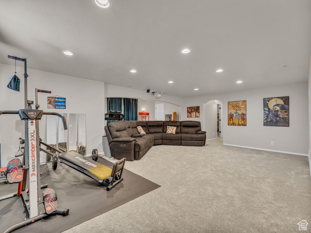 Exercise area with arched walkways, recessed lighting, and carpet