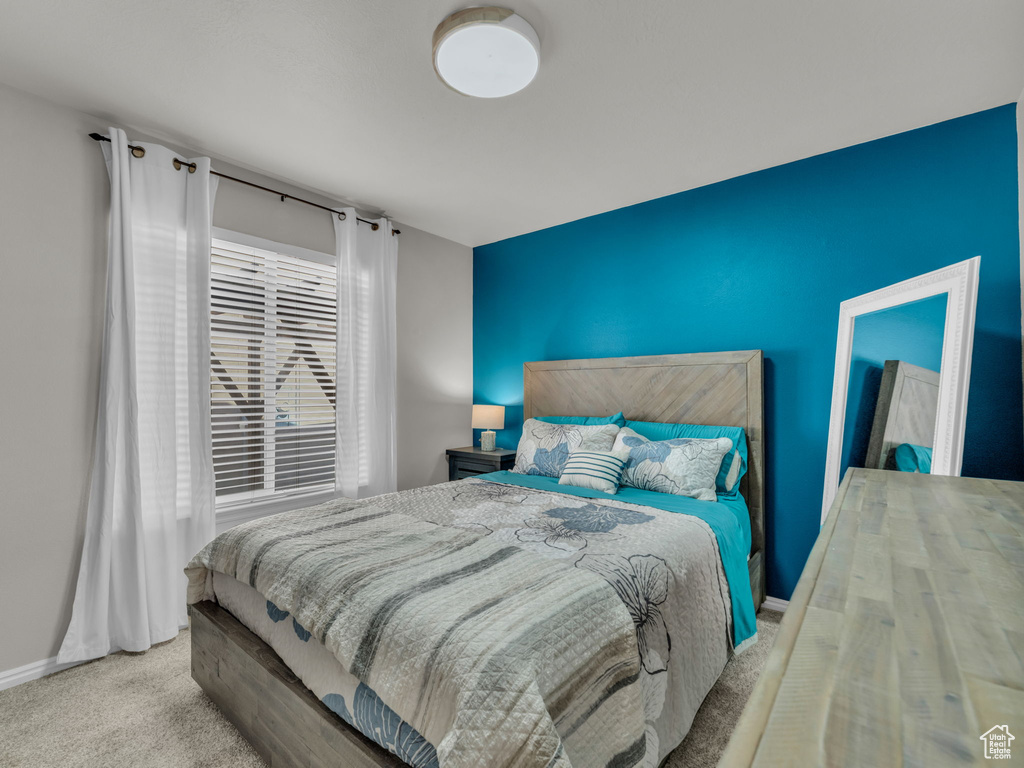 Carpeted bedroom with baseboards