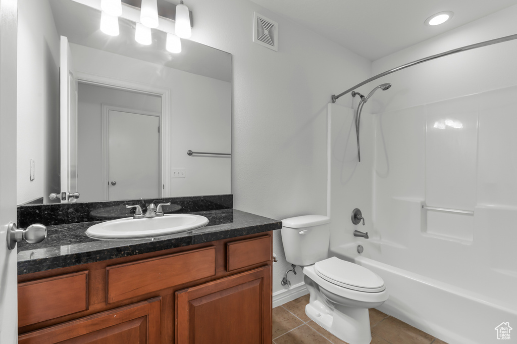 Bathroom with vanity, tile patterned flooring, and shower / bathtub combination