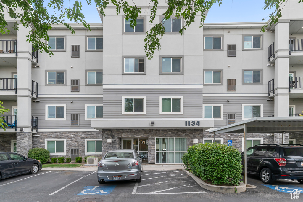 View of property with uncovered parking