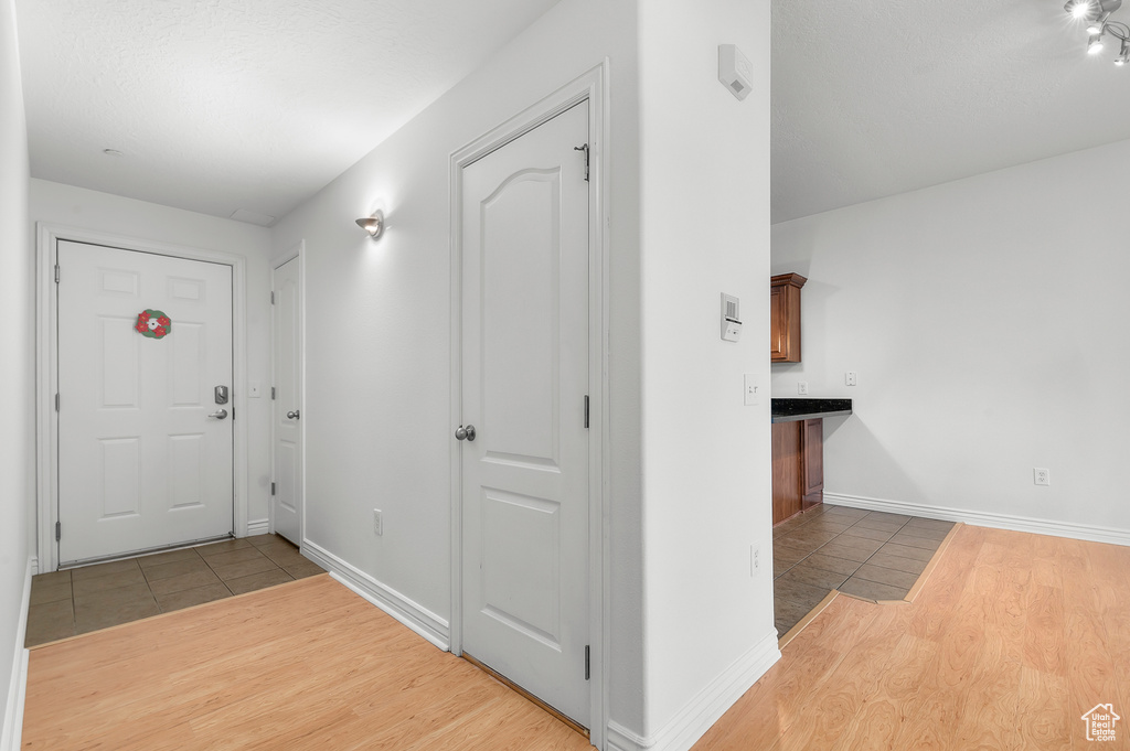 Foyer featuring light wood-type flooring and baseboards