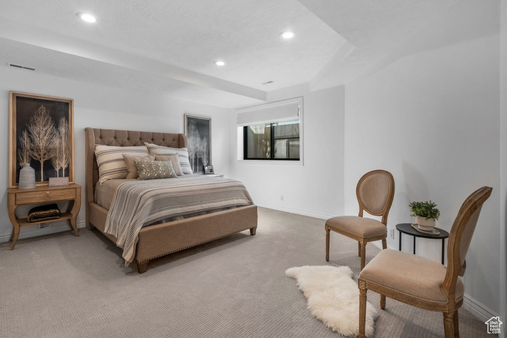 Bedroom with light carpet and recessed lighting