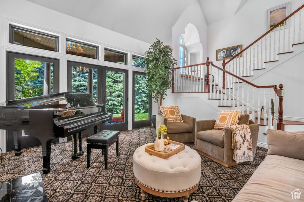 Living area featuring stairs and high vaulted ceiling