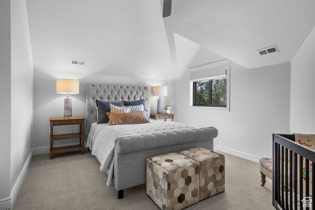 Bedroom with carpet, vaulted ceiling, and ceiling fan