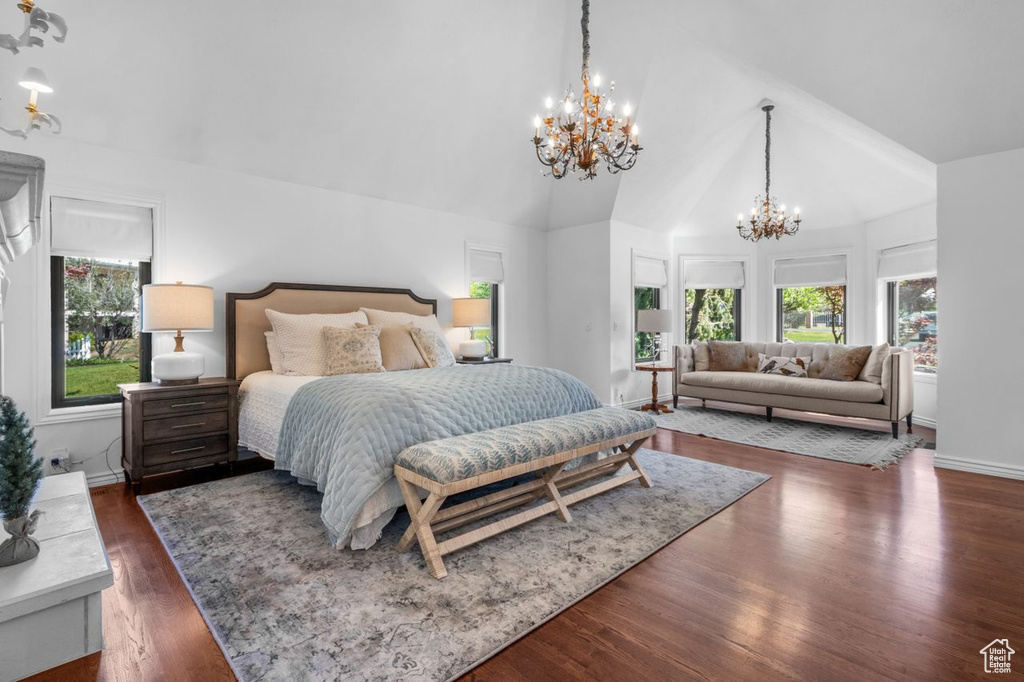 Bedroom with a chandelier, multiple windows, wood finished floors, and high vaulted ceiling