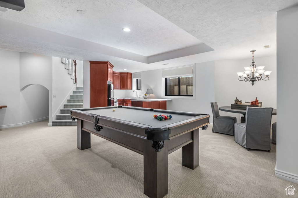 Recreation room with light carpet, a textured ceiling, pool table, recessed lighting, and a chandelier