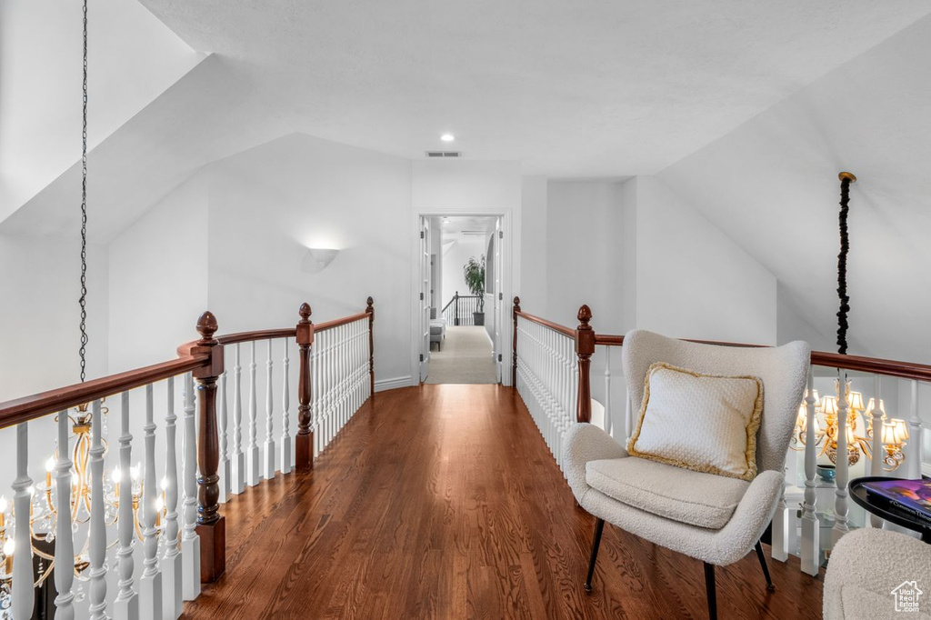 Hall with an upstairs landing, lofted ceiling, wood finished floors, and recessed lighting