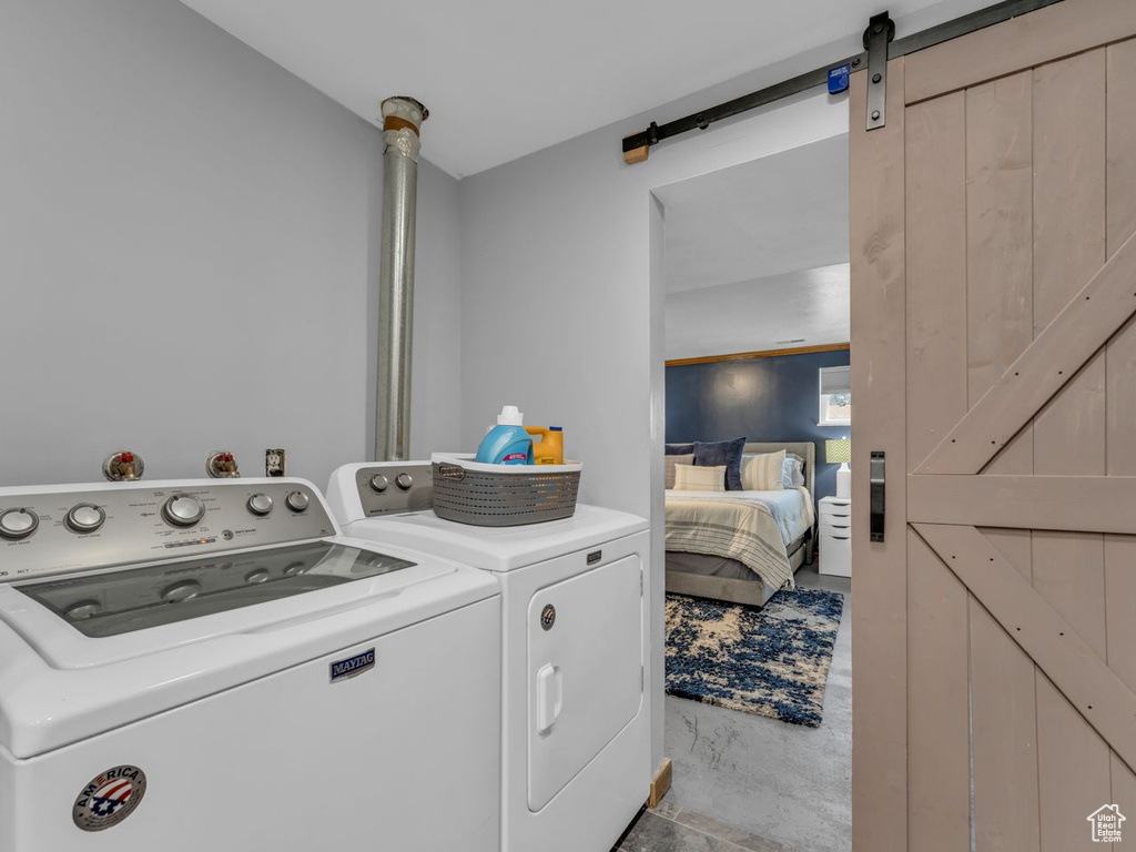 Laundry area featuring washer and clothes dryer and a barn door