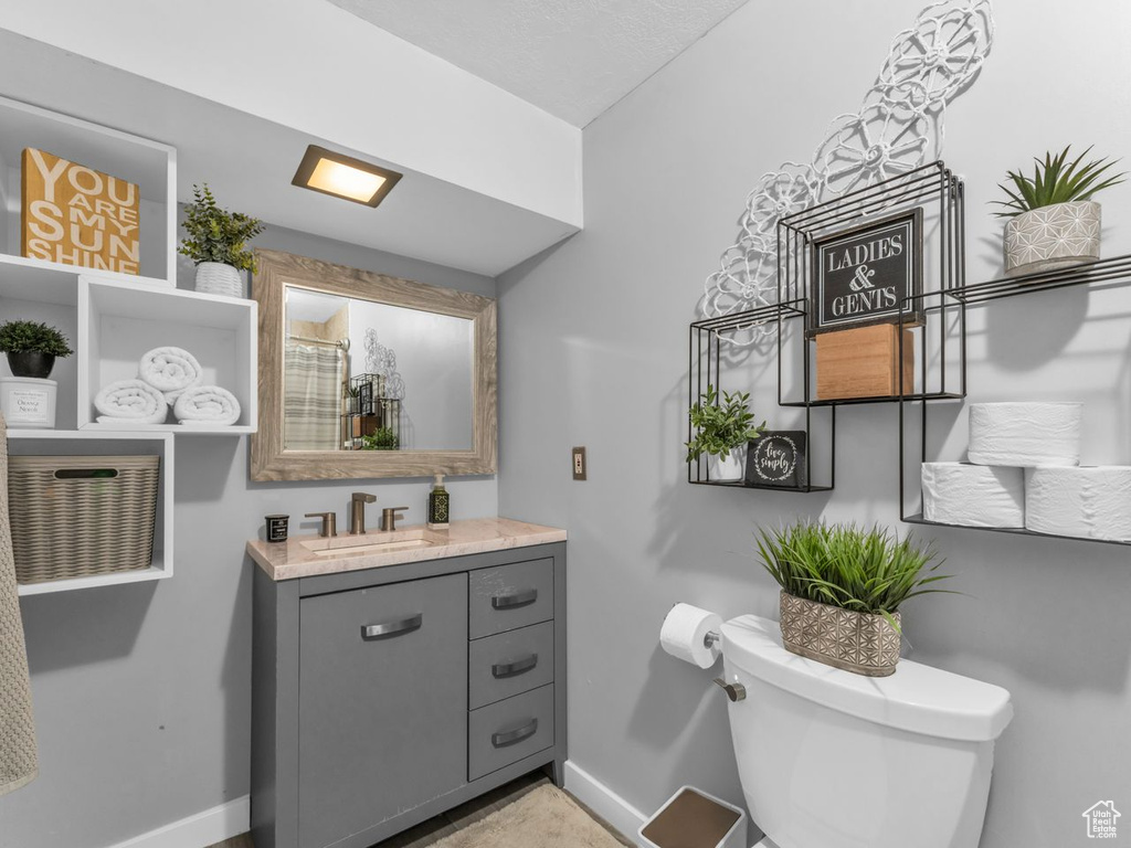 Full bath with vanity and a shower with curtain