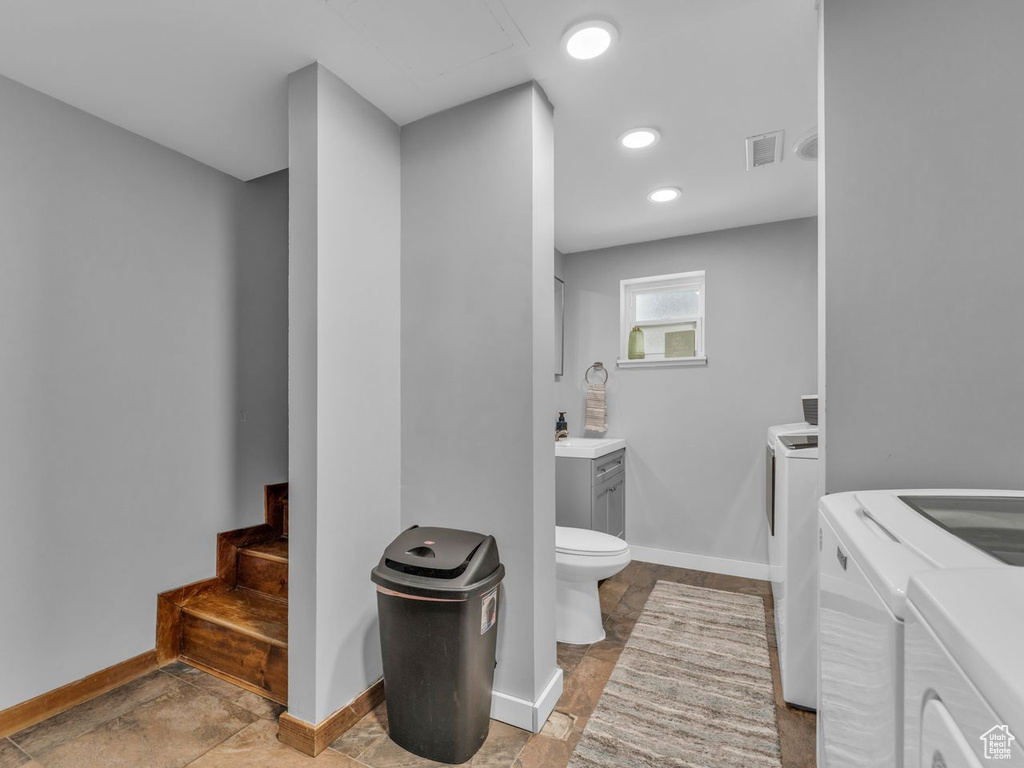 Bathroom featuring washer and clothes dryer and vanity