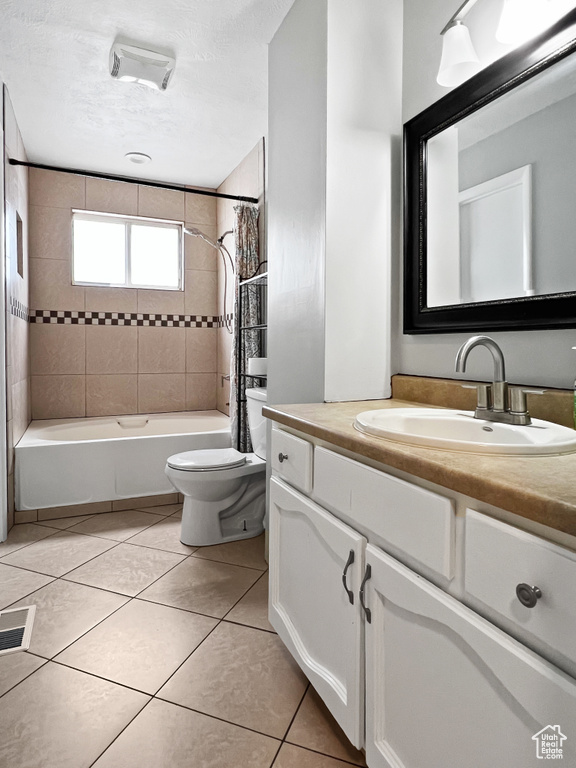 Full bathroom featuring vanity, shower / tub combo, and tile patterned floors