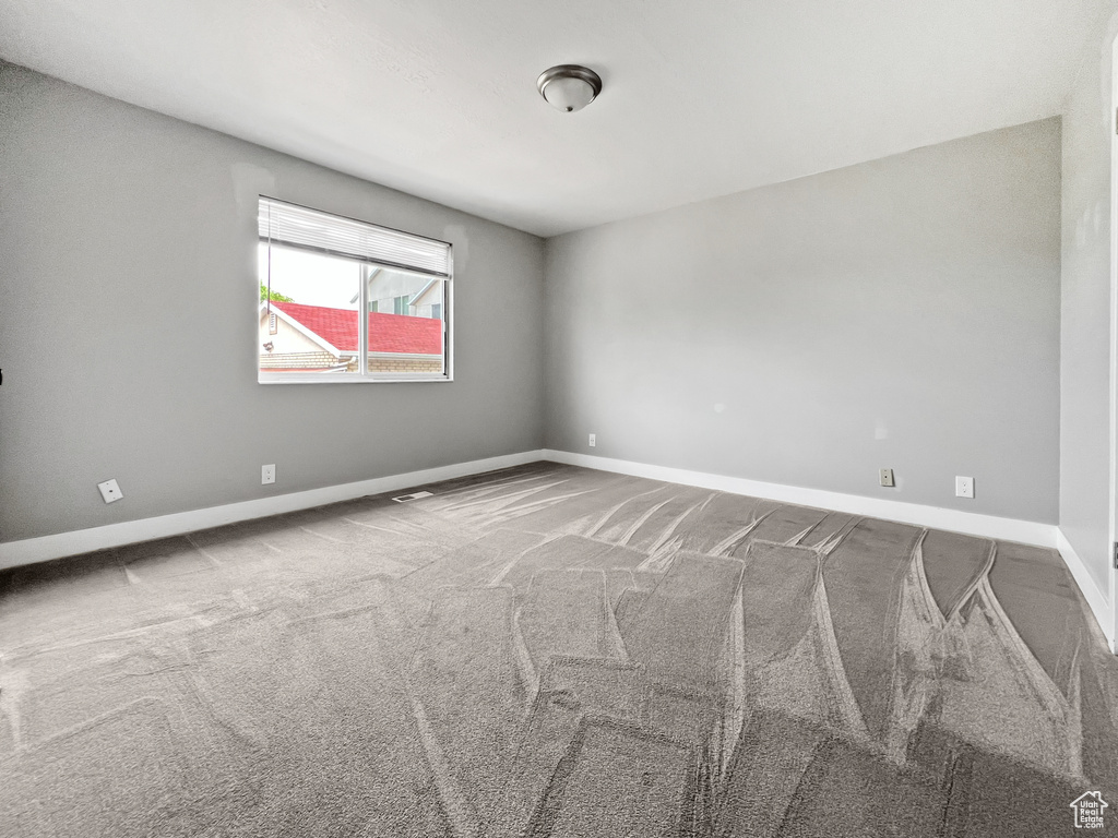 Unfurnished room with carpet and baseboards