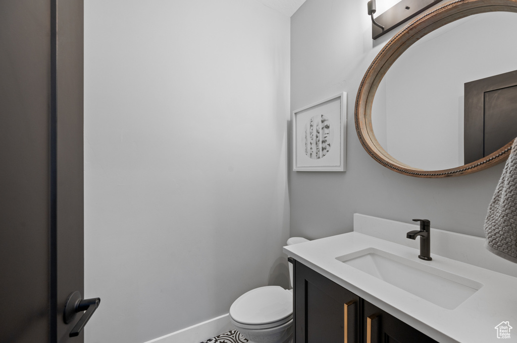 Half bath with vanity and toilet