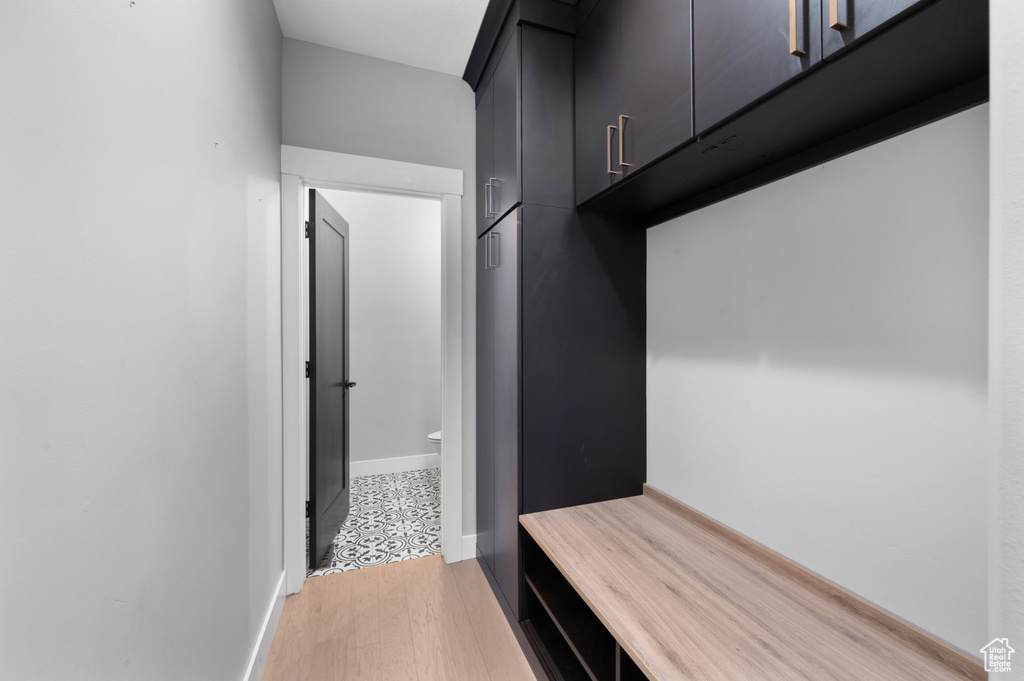 Mudroom featuring light wood-style floors and baseboards