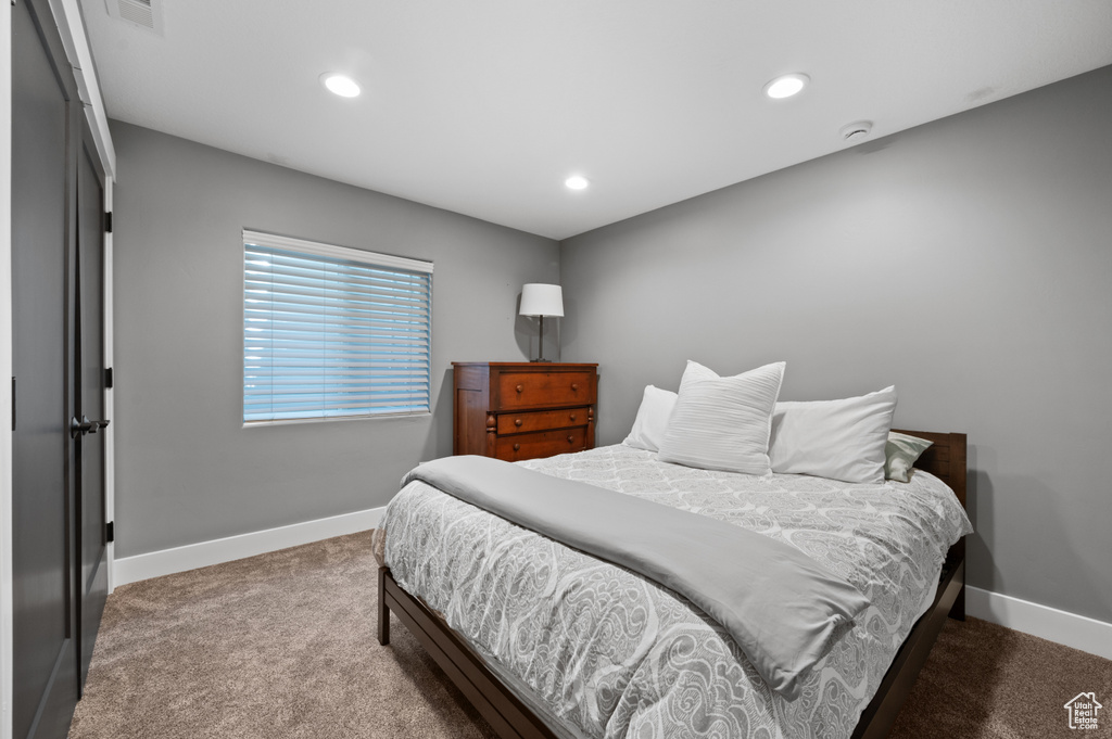 Carpeted bedroom featuring baseboards and recessed lighting