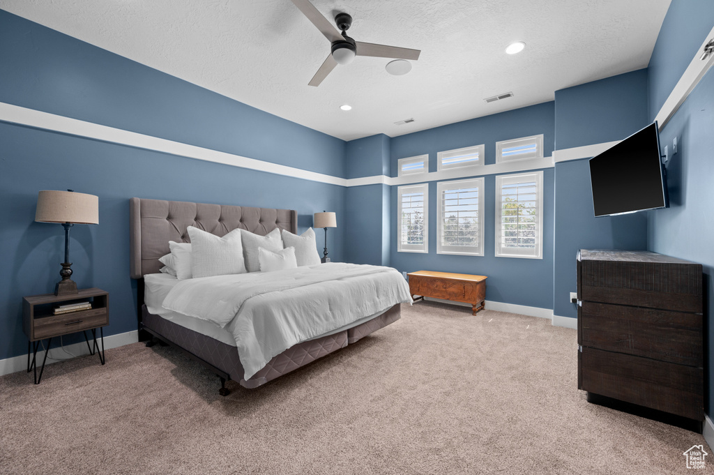 Bedroom with carpet, ceiling fan, recessed lighting, and a textured ceiling