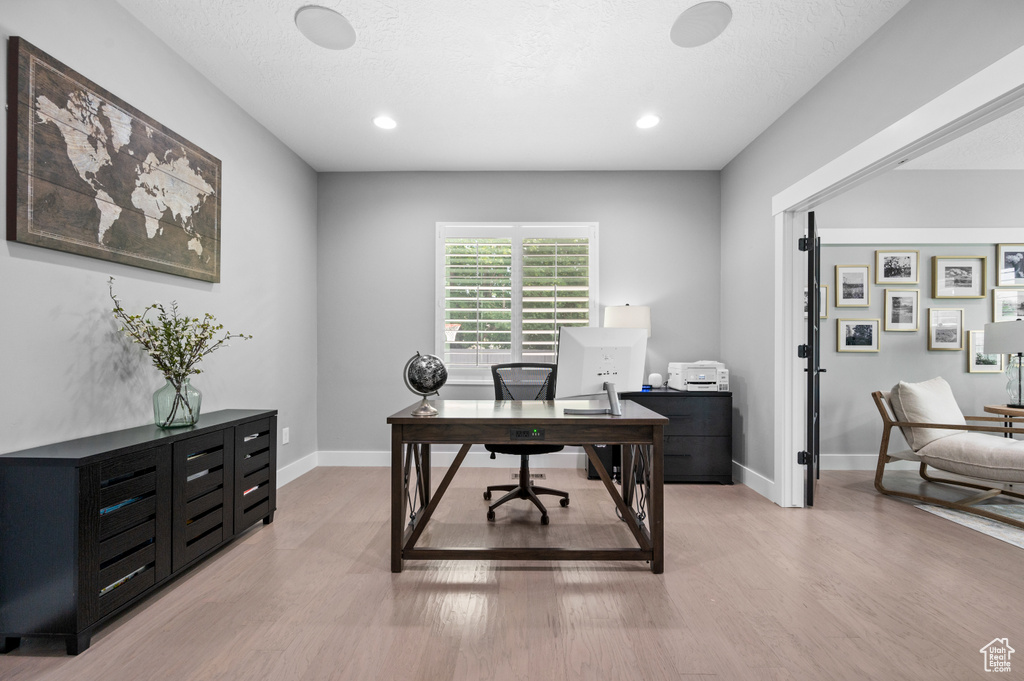 Office featuring light wood-type flooring and recessed lighting