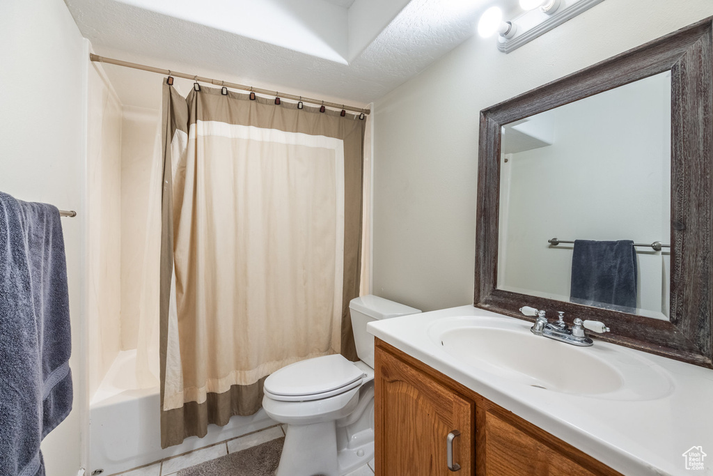 Full bathroom featuring vanity, tile patterned floors, and shower / bath combo