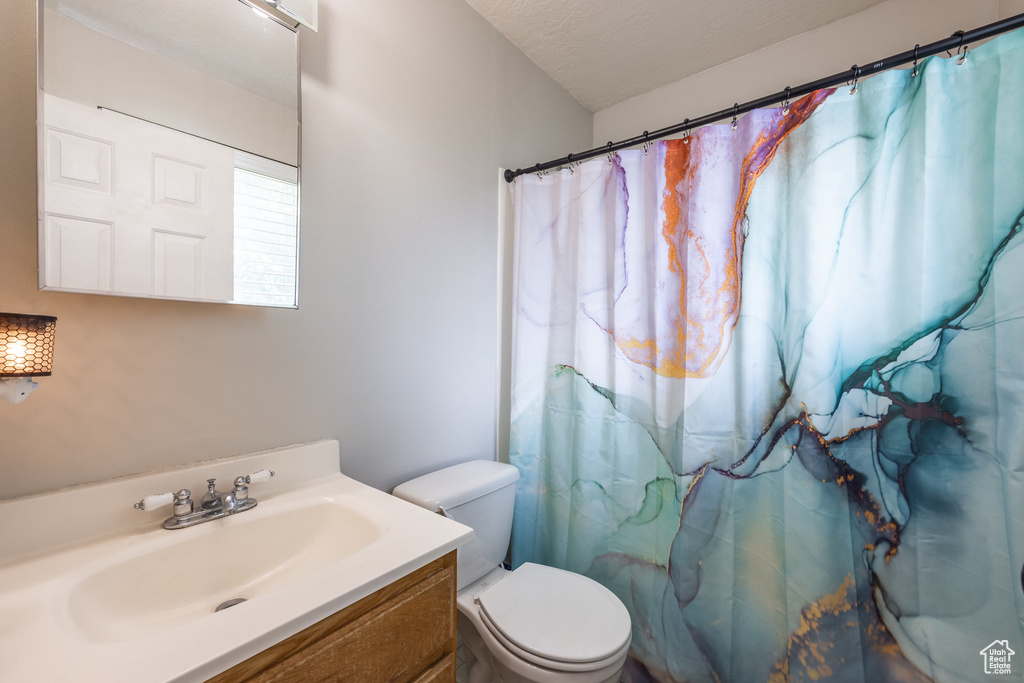 Bathroom with vanity and curtained shower