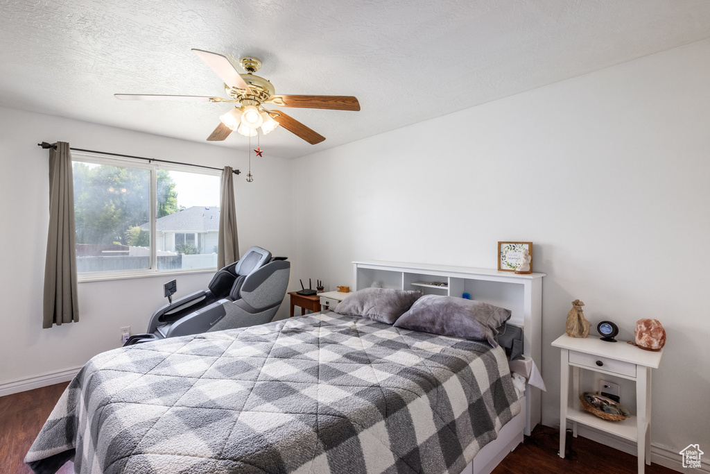 Bedroom featuring dark wood-type flooring and ceiling fan