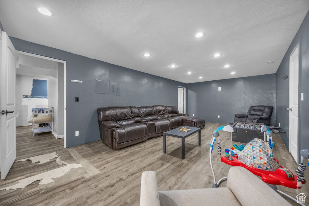Living room with light wood-style floors and recessed lighting