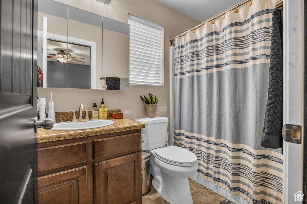 Full bathroom with vanity, ceiling fan, tile patterned flooring, and a shower with shower curtain