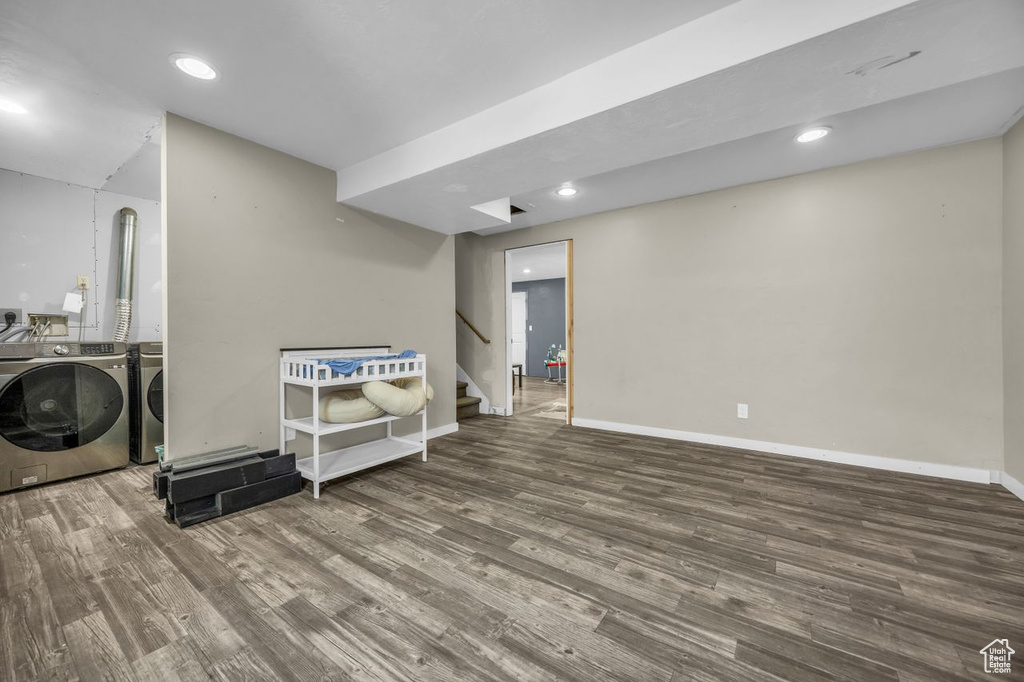 Basement featuring separate washer and dryer, wood finished floors, stairs, and recessed lighting
