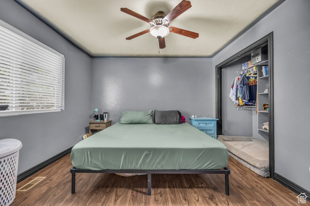 Bedroom with wood finished floors and ceiling fan