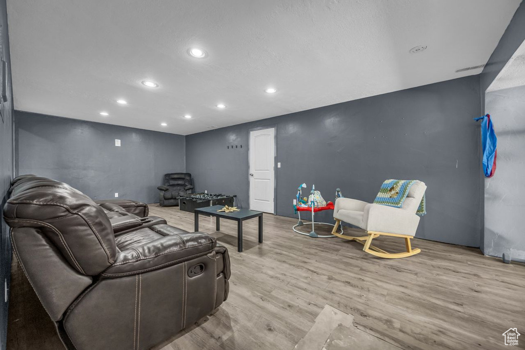Living area with recessed lighting and wood finished floors