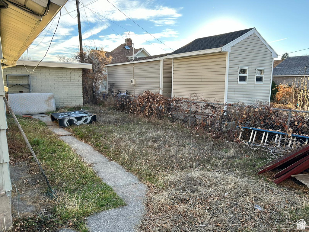 View of side of property featuring a shingled roof