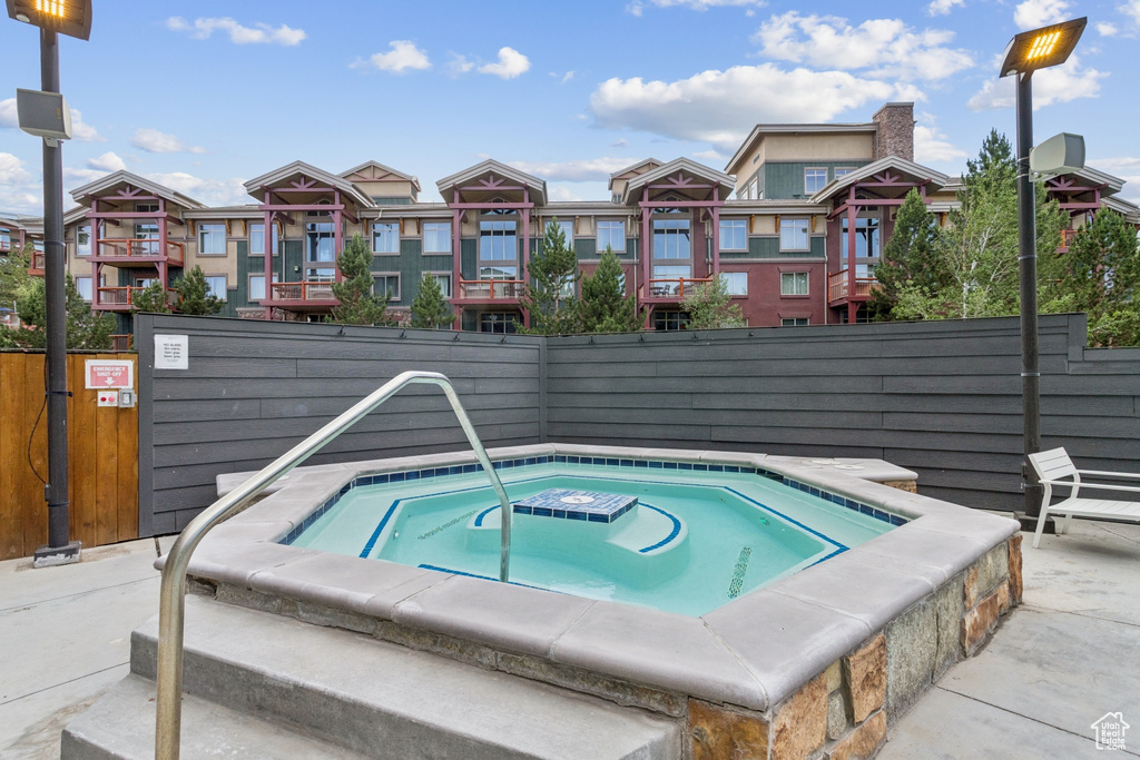 View of pool featuring a hot tub